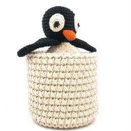 A handcrafted, off-white cotton basket with a crocheted penguin design, measuring 13cm high and 12cm in diameter. Suitable for use as a plant pot or decorative storage.
