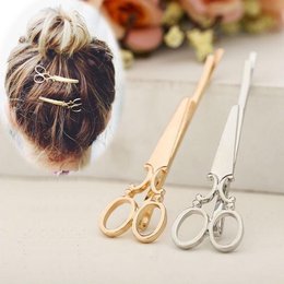 Unique design metal hair barrettes in gold and silver colors. Decorative hair accessories with a scissor-like shape.