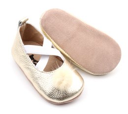 Soft, metallic gold leather baby ballerina shoes with criss-cross straps and golden tassels.