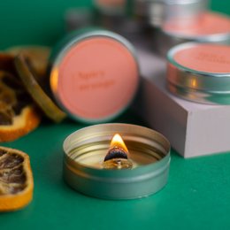  Spicy orange scented soy candle in a round gold tin container. The candle has a warm, citrusy aroma with notes of cinnamon and clove.