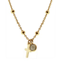Gold-tone cross necklace with a small charm pendant.