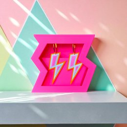  Pink stud earrings with lightning bolt design, geometric shape, bold neon style, statement jewelry.