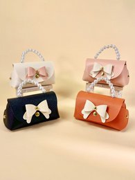  Elegant gift bags with chic bows and pearls, available in orange, black, cream, and pink colors.