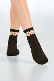 Black socks with white polka dot pattern. Soft, comfortable material. Suitable for casual or formal wear.