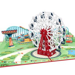 A colorful pop-up card featuring a ferris wheel, with a red and white design on the front cover.