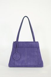 Violet suede handbag with a structured silhouette, dual top handles, and a detachable charm.