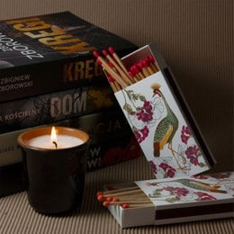 Decorative box of long matches featuring a colorful design with a peacock and floral patterns.