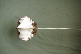 Two wooden shelves displaying various decorative items, including a potted plant, a glass vase, and a decorative object.