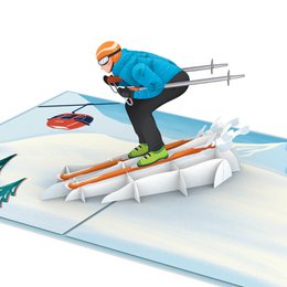 A pop-up card featuring a skier on the slopes, with skis, poles, and a snowy mountain backdrop. The card is designed for birthday celebrations.