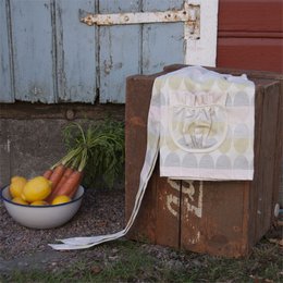  A pink and white striped apron with a ruffled design and a tie waist. The apron appears to be made of a lightweight, cotton-like material.