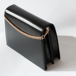 Black leather handbag with gold-tone hardware and chain strap.