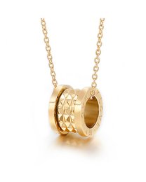 A gold-toned pendant necklace featuring a circular charm with a textured, ribbed design.