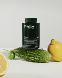 Philo Detox is a green, cylindrical supplement bottle surrounded by green vegetables and a lemon, suggesting a natural, healthy product.
