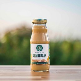 Pure ginger juice in a 200ml glass bottle. Ginger tea, ginger shot, and ginger flavored drink. Organic and natural ingredients.