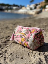  Vibrant pink cotton toiletry pouch with crane print, available in medium, large, and small sizes.