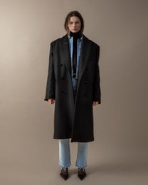 A long, black double-breasted coat with a high collar and flared sleeves.