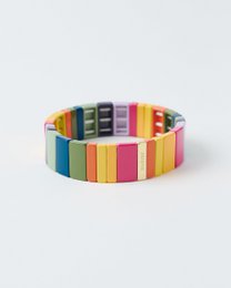  Colorful beaded bracelet with rainbow stripes, multicolor tile design, vibrant yellow pink purple teal orange blocks.