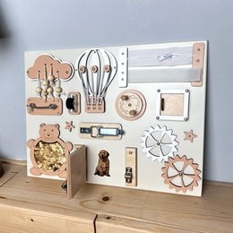 Handcrafted extra small beige busy board with various sensory elements including shapes, textures, and colors. Designed for young children to explore and develop fine motor skills.
