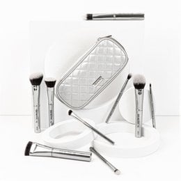 A set of high-quality makeup brushes in a stylish, quilted white case. The brushes feature sleek, silver-toned handles and soft, dense bristles for precise and flawless makeup application.