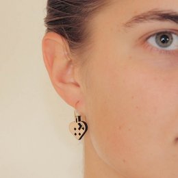 Heart-shaped hoop earrings in gold and silver tones, featuring a minimalist design with a cutout heart pattern.