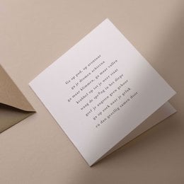 A white greeting card with a simple text message in black font, conveying a message of good luck and well-wishes.