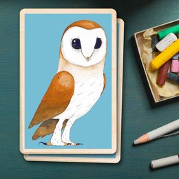 Durable wooden card featuring a detailed illustration of a barn owl. The card is part of a collection of cards with nature-inspired artwork.