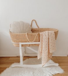 "Linen shell-shaped cushion in a neutral sand color, featuring a scalloped edge design."