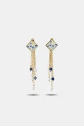 "Gold drop earrings with lapis blue and pearl stones, detachable geometric diamond-shaped tops, elegant dangle style"