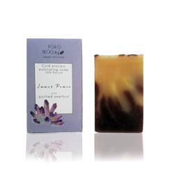 Exfoliating soap bar with natural ingredients including lavender and rosemary. Rectangular shape with purple and brown tones.