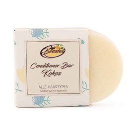 Coconut-scented conditioner bar with a round, solid shape.