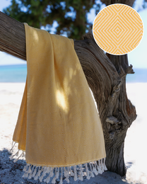  A large, yellow Turkish hammam towel with a textured pattern and fringe trim, suitable for use in the spa, sauna, or at the beach.