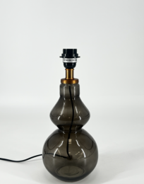 Decorative glass table lamp with a unique, textured glass base in a smoky gray color. The lamp has a simple, modern design with a black lamp shade.