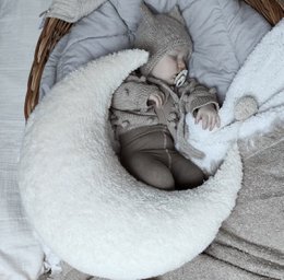  Soft white teddy cotton nursing pillow, crescent moon shape, neutral beige gray tones, ergonomic baby feeding support pillow.