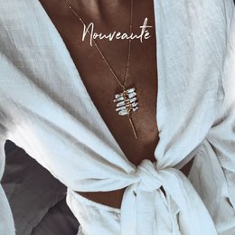 Delicate silver-toned necklace charm with intricate details, perfect for adding a touch of elegance to any outfit.
