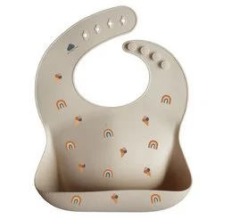 Silicone bib with rainbow-shaped patterns in neutral colors. Made of soft, flexible silicone material. Suitable for babies and toddlers.