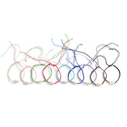  Colorful woven bracelets with cowrie shell accents. Available in a variety of colors including blue, brown, ecru, green, cobalt blue, light pink, purple, pink, and black.