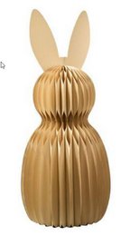  A decorative standing rabbit figure made of brown material, likely paper or cardboard, with large ears and a pleated or folded design.