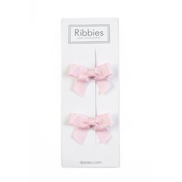 A pair of light pink hair bows with a bow design. The bows are made of a soft, ribbon-like material and have a simple, classic style.