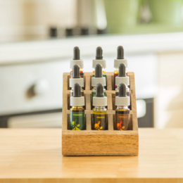 Handmade wooden spice rack with 9 compartments for storing and organizing spice bottles. Compact kitchen storage shelf made of natural wood.