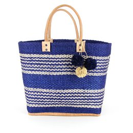 Navy and white striped woven basket bag with sisal handles and decorative pom-pom charm.