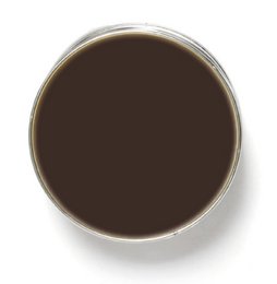 A round, dark brown chocolate-colored wax candle in a glass container.