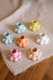  Colorful, flower-shaped candle holders in various pastel shades including white, beige, pink, yellow, orange, light blue, and mint.