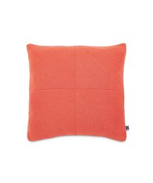 Coral-colored cushion cover with a square, textured design.