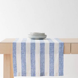 Linen table runner in off-white and blue striped pattern, suitable for dining table decor.