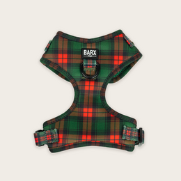 Adjustable plaid dog harness in green, red, and black colors. Made of durable material with a sturdy buckle closure. Suitable for small to medium-sized dogs.
