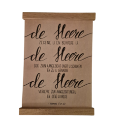A Christian poster with the text "de Heure" written in a cursive font on a brown paper background.