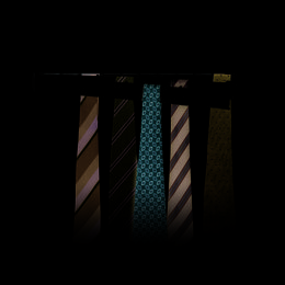  A tie hanger with capacity for up to 30 ties, featuring a variety of tie designs including striped and patterned ties.