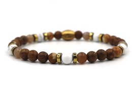  Beaded bracelet with mixed brown and gold-toned beads.

The ENAM Campur Naturel bracelet features a mix of brown and gold-toned beads in a variety of shapes and sizes, including round, oval, and cylindrical beads. The bracelet is available in three size options: XS-S, M-L, and XL-XXL, and in two color variations: silver and gold. The beads appear to be made of natural materials, creating a rustic, earthy aesthetic.