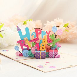  A colorful 3D birthday card with a large cake, balloons, and party decorations. The card is open to reveal a detailed pop-up scene celebrating a birthday.