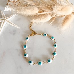 Gold and blue beaded bracelet with turquoise-colored stones and gold-colored accents.
